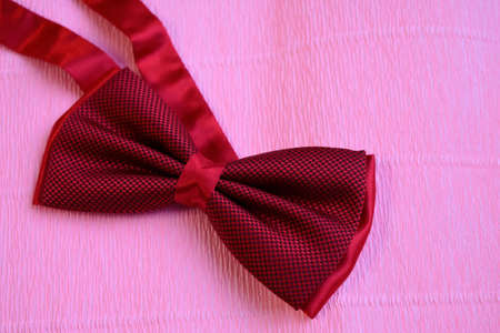red male bow tie on a light background