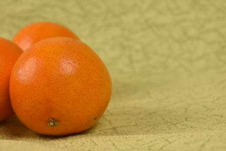 ripe fresh tangerines on a light green background