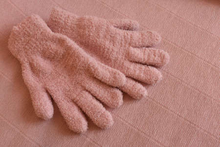 pink gloves on a pink backgroundの写真素材