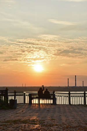 people enjoy the sunset on the riverの写真素材