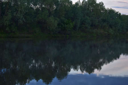 colorful and misty dawn over a small river
