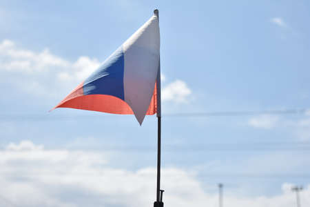 Russian flag against the blue sky