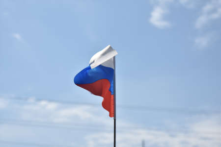 Russian flag against the blue sky