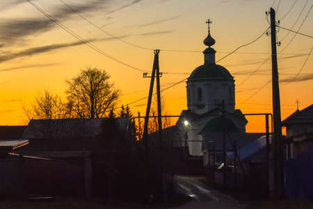 Beautiful village church at sunsetの写真素材