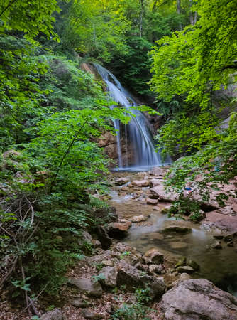 beautiful waterfall in the mountain forestの写真素材