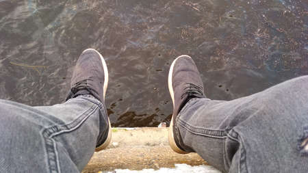 feet on the background of water