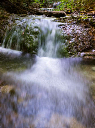 beautiful waterfall in the mountain gorge