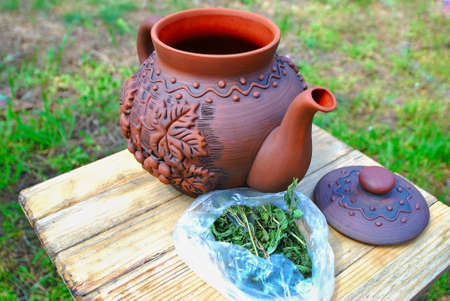 ceramic teapot on the background of grassの写真素材
