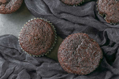 Delicious and fresh chocolate muffins on a gray ceramic table.の写真素材