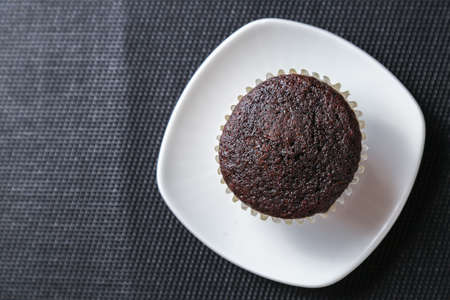 Delicious and fresh chocolate muffins on a gray ceramic table.の写真素材