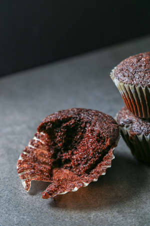 Delicious and fresh chocolate muffins on a gray ceramic table.の写真素材