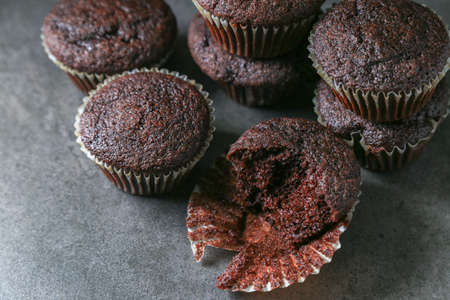 Delicious and fresh chocolate muffins on a gray ceramic table.の写真素材