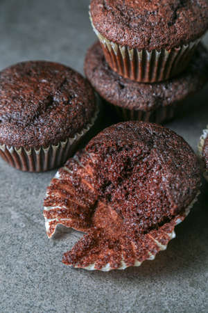Delicious and fresh chocolate muffins on a gray ceramic table.の写真素材
