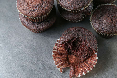 Delicious and fresh chocolate muffins on a gray ceramic table.の写真素材