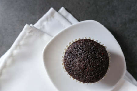 Delicious and fresh chocolate muffins on a gray ceramic table.の写真素材