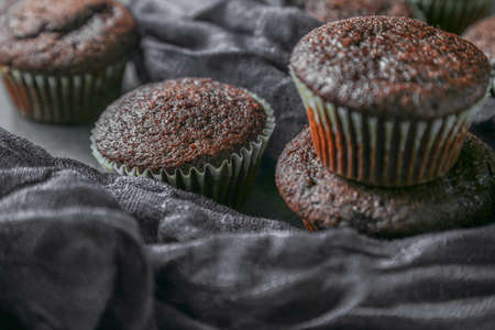 Delicious and fresh chocolate muffins on a gray ceramic table.の写真素材