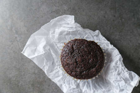 Delicious and fresh chocolate muffins on a gray ceramic table.の写真素材