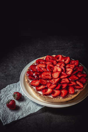 Homemade strawberry pie with syrup on a ceramic platter.の写真素材