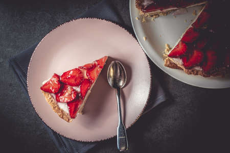 Homemade strawberry pie with syrup on a ceramic platter. Piece of delicious homemade fresh...
