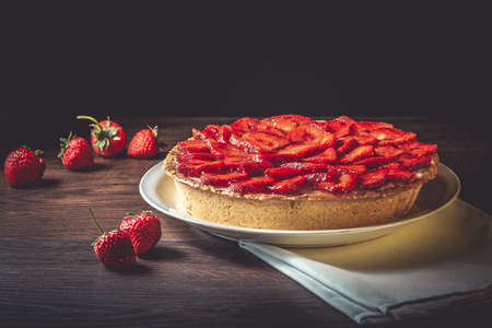 Homemade strawberry pie with syrup on a ceramic platter.の写真素材