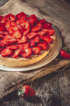 Homemade strawberry pie with syrup on a ceramic platter.の写真素材