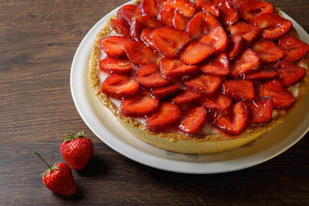Homemade strawberry pie with syrup on a ceramic platter.の写真素材