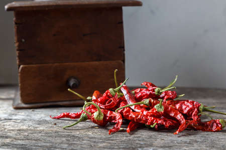 Dry red chili peppers on a wooden rustic table.の写真素材