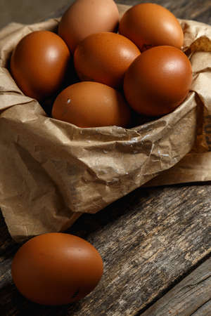 Ecological farm chicken eggs on a rustic wooden table. Healthy food. Delicious and nutritious.の写真素材