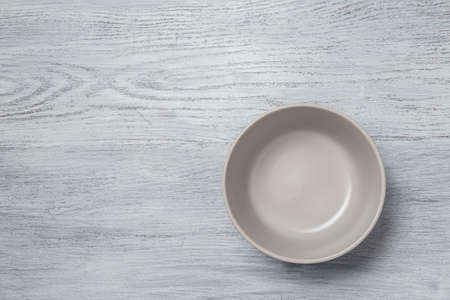 A gray plate on a bleached wood table. Top view.の写真素材