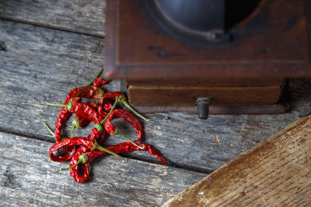 Dry red chili peppers on a wooden rustic table.の写真素材