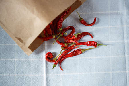 Dry red chili peppers on a wooden rustic table.の写真素材