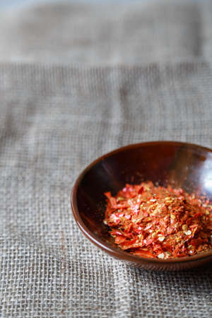 Dry red chili peppers on a wooden rustic table.