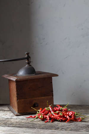 Dry red chili peppers on a wooden rustic table.の写真素材