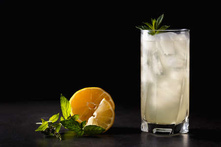 Refreshing summer non-alcoholic lemonade with ice, fresh mint and lemon. Top view, place for text. Fruit background with copy space. Still life food.の写真素材