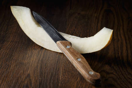 Sliced melon, honey melon on wooden table background. Very healthy, natural, vegetarian food.の写真素材