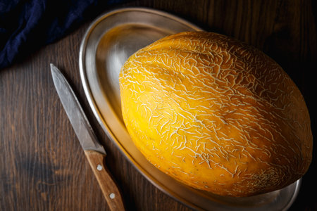 Whole melon, honey melon on wooden table background. Very healthy, natural, vegetarian food.の写真素材