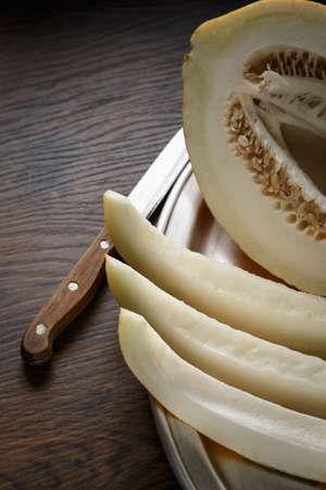 Whole and sliced melon, honey melon on wooden table background. Very healthy, natural, vegetarian...