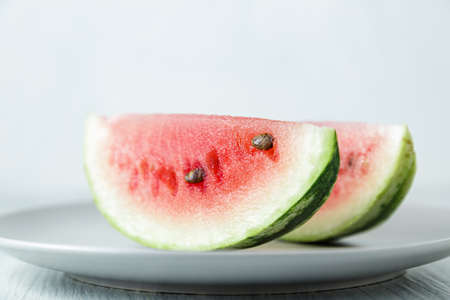 Sliced watermelon, honey watermelon on wooden table background. Very healthy, natural, vegetarian food.の写真素材