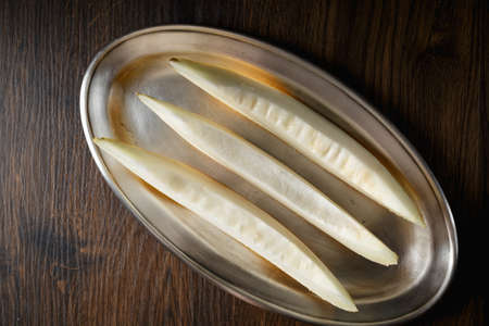 Sliced melon, honey melon on wooden table background. Very healthy, natural, vegetarian food.の写真素材