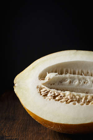 Whole melon, honey melon on wooden table background. Very healthy, natural, vegetarian food.の写真素材