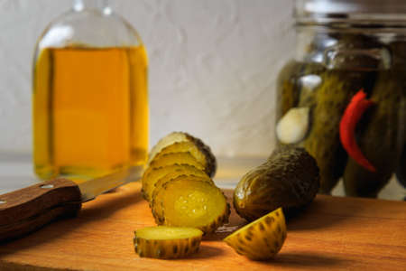 Pickled cucumbers in a jar with herbs and spices. Sliced pickled cucumber. Healthy fermented food.の写真素材