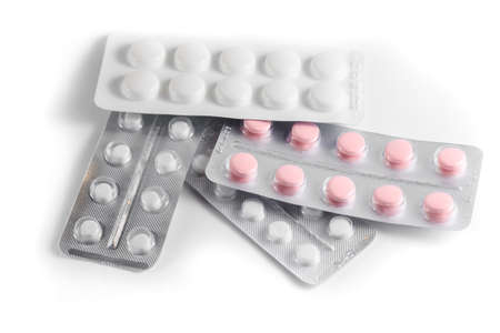 Close-up of a couple white pills or capsules on an isolated white background. selective focus.の写真素材
