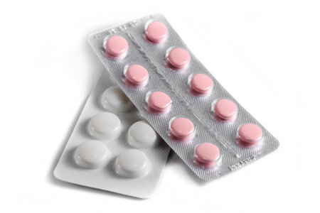Close-up of a couple white pills or capsules on an isolated white background. selective focus.の写真素材
