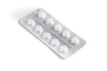 Close-up of a couple white pills or capsules on an isolated white background. selective focus.
