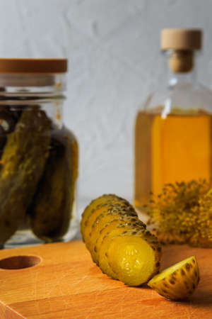 Pickled cucumbers in a jar with herbs and spices. Sliced pickled cucumber. Healthy fermented food.の写真素材