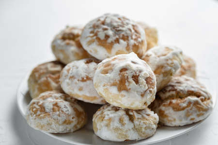 Plate with tasty homemade gingerbread cookies on white background, close up. selective focus.の写真素材