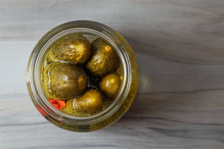 Pickled cucumbers in a jar with herbs and spices. Healthy fermented food.の写真素材