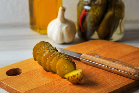 Pickled cucumbers in a jar with herbs and spices. Sliced pickled cucumber. Healthy fermented food.の写真素材