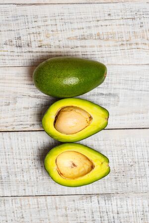 Sliced green avocado on a white surface in provence styleの写真素材