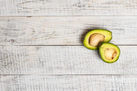 Sliced green avocado on a white surface in provence styleの写真素材